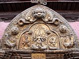 Kathmandu Patan Durbar Square 17 Gilded Torana With Ganesh, Shiva, Parvati and Kirtimukha Face Of Glory At The Top Above Patan Museum Golden Gate Sun Dhoka Entrance